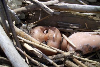 doll in garbage pile