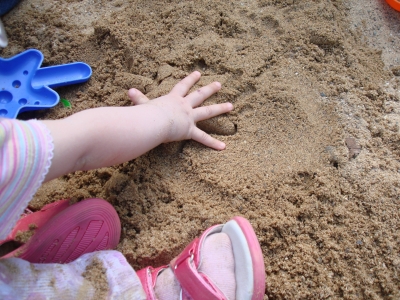 lia's hand im sand