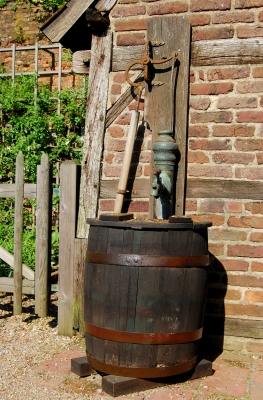 Handpumpe mit altem Wasserfass