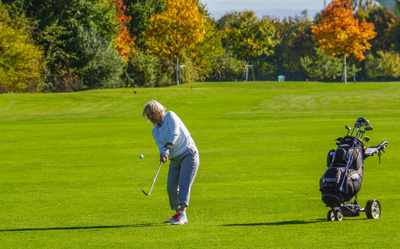 Seniorin beim Golfspiel