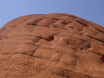 Detailaufnahme heiliger Berg Uluru in Australien vor blauem Himmel.